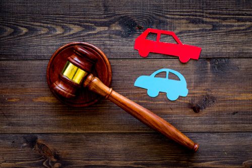 what happens if you win a car accident lawsuit concept, two cars near judge gavel