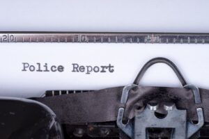 Typewriter with a sheet of paper displaying "Police Report," emphasizing the importance of documentation in car accident legal cases.