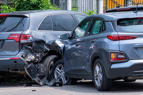 Rideshare accident scene showing damaged vehicles, highlighting the complexities of liability and insurance coverage in Uber and Lyft incidents.