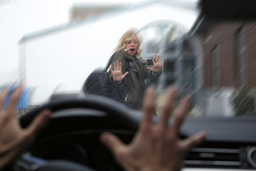Driver’s view of a woman raising her hands in fear as a car approaches — illustrating the danger of pedestrian accidents in Wilmington NC.