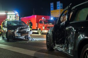 NC Car Accident Lawyer presents an image of a car accident claims investigation underway at a nighttime crash scene with emergency responders and damaged vehicles.