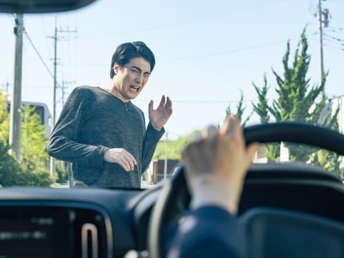 A man about to be ran over by a person to represent a case where a pedestrian accident lawyer would review.