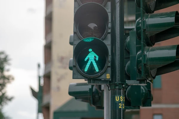 A traffic light with a pedestrian crossing signal